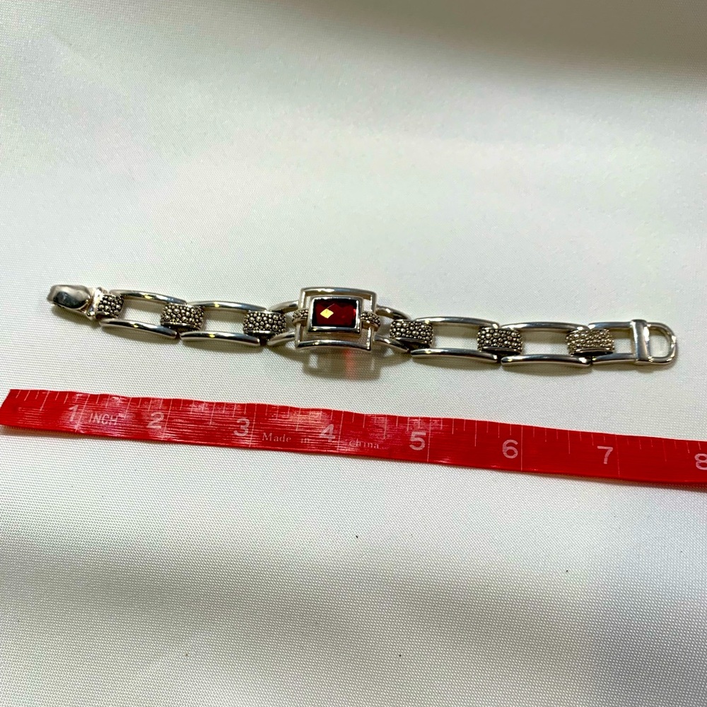 Silver rectangle, red center jewel